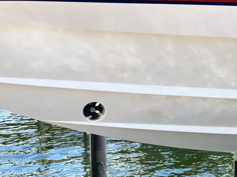 Slide: The Image of Close-up of Intrepid 475 Sport Yacht 2018 hull by the water. - 12