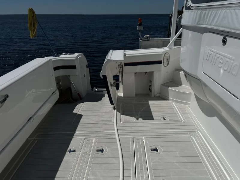 Slide: The Image of Intrepid 475 Sport Yacht 2018, spacious deck by the water. - 14