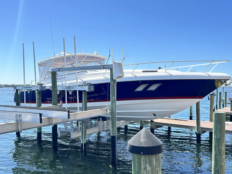 Slide: The Image of 2018 Intrepid 475 Sport Yacht on a boat lift at the dock. - 2
