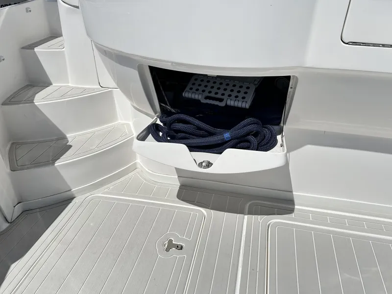 Slide: The Image of Intrepid 475 Sport Yacht 2018 with open storage compartment and rope. - 22