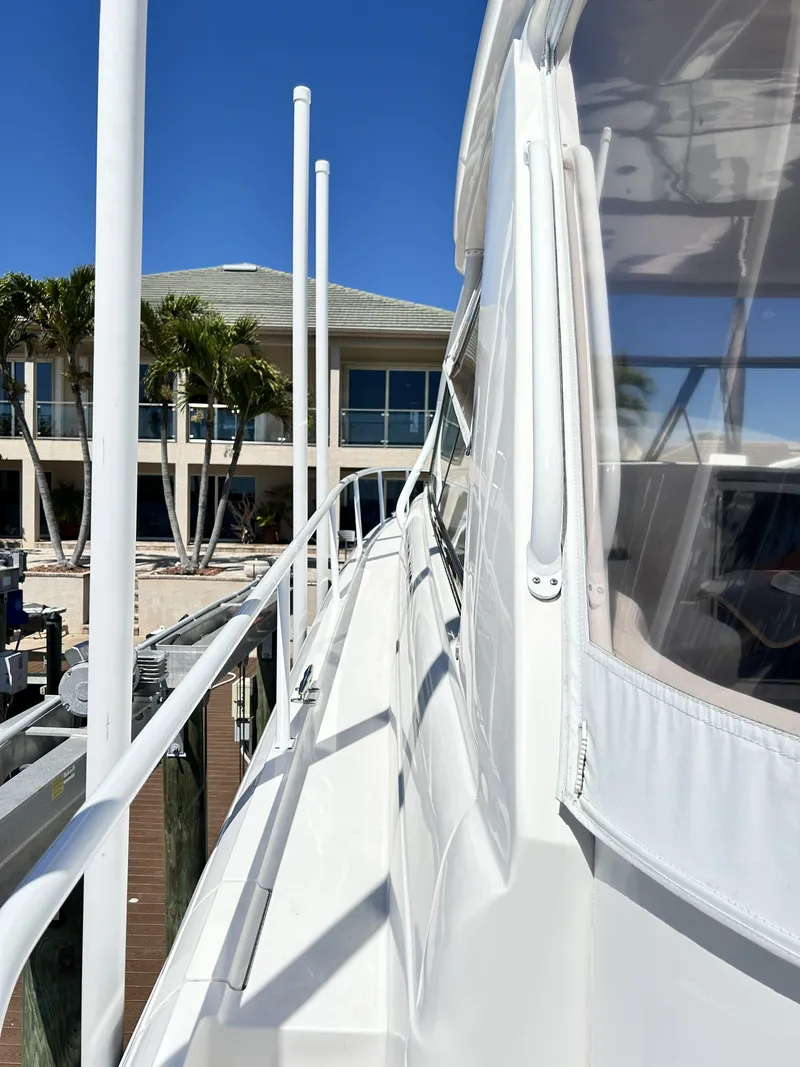 Slide: The Image of Intrepid 475 Sport Yacht 2018 docked with palm trees in background. - 23