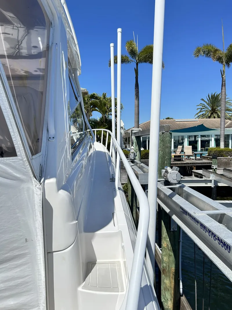 Slide: The Image of 2018 Intrepid 475 Sport Yacht docked with palm trees in background. - 24