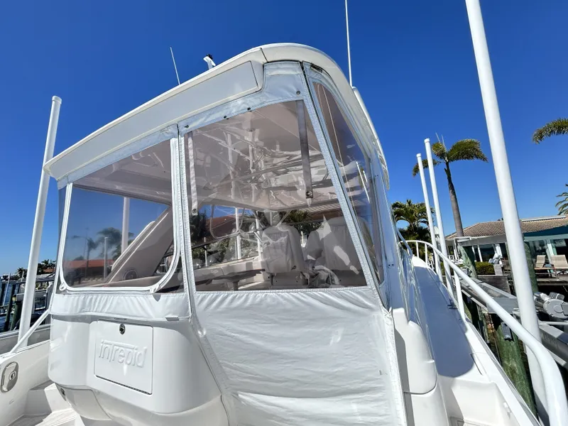 Slide: The Image of Intrepid 475 Sport Yacht 2018 with clear sky and palm trees. - 25