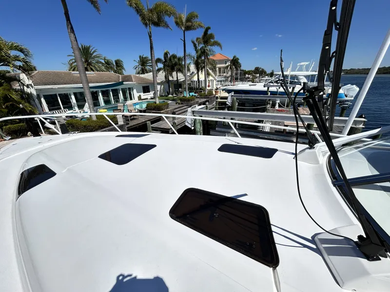 Slide: The Image of Intrepid 475 Sport Yacht 2018 docked with palm trees in the background. - 43