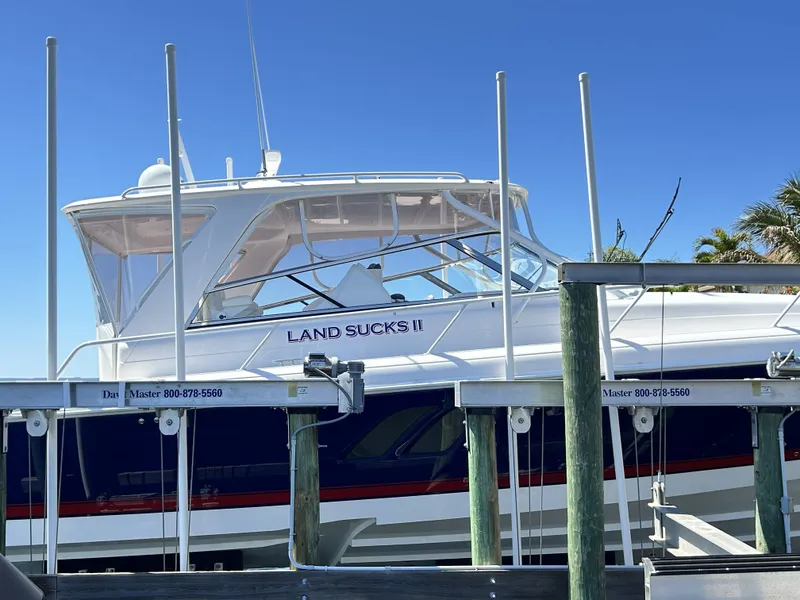 Slide: The Image of 2018 Intrepid 475 Sport Yacht docked, featuring blue and white design. - 6