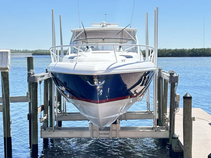 Slide: The Image of Intrepid 475 Sport Yacht 2018 on boat lift by the water. - 7