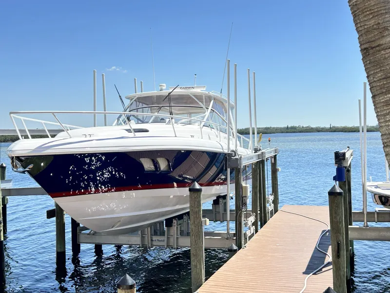 Slide: The Image of 2018 Intrepid 475 Sport Yacht on a boat lift by the water. - 9