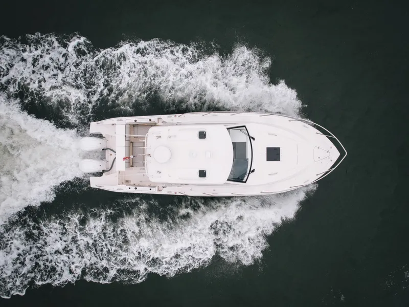 Slide: The Image of Aerial view of 2023 Pursuit OS 325 Offshore on water. - 2