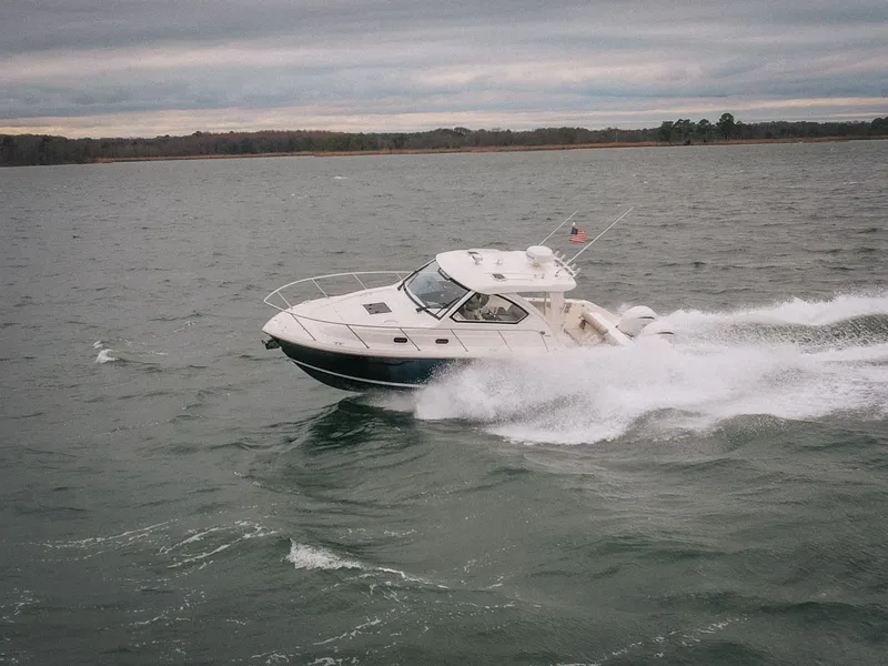 Slide: The Image of 2023 Pursuit OS 325 Offshore cruising on choppy waters. - 3