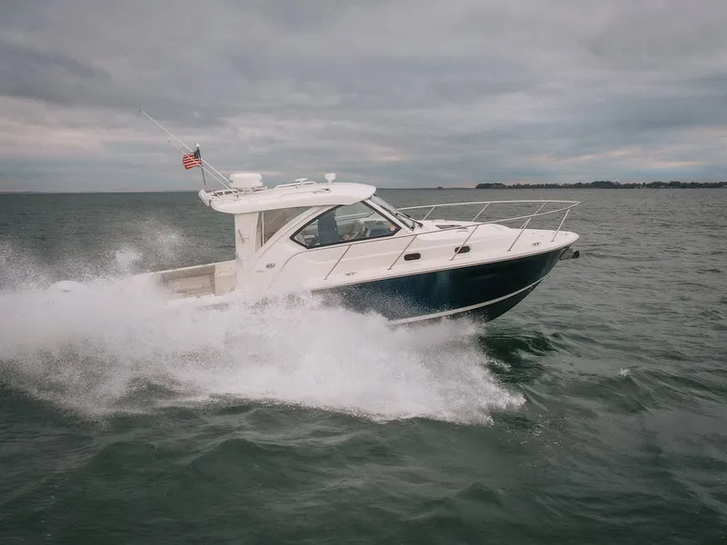 Slide: The Image of 2023 Pursuit OS 325 Offshore boat navigating choppy waters. - 4