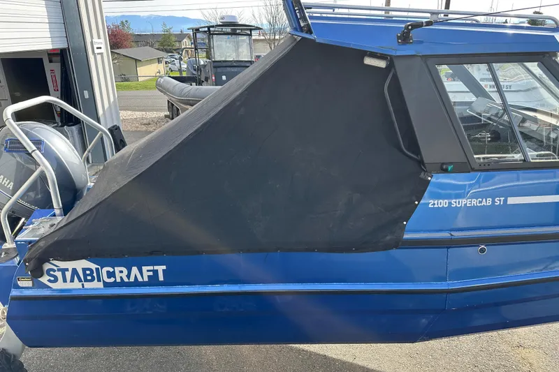 Slide: The Image of 2017 Stabicraft 2100 Supercab boat with black cover, parked outdoors. - 14