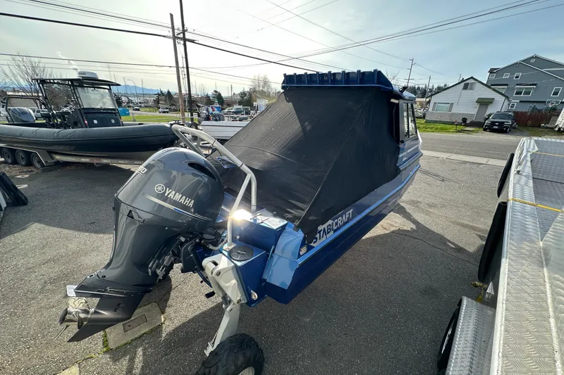 Slide: The Image of 2017 Stabicraft 2100 Supercab with Yamaha outboard motor, parked outdoors. - 15