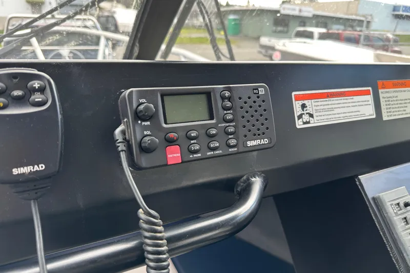 Slide: The Image of Simrad radio system on 2017 Stabicraft 2100 Supercab dashboard, featuring control panel and warning labels. - 19