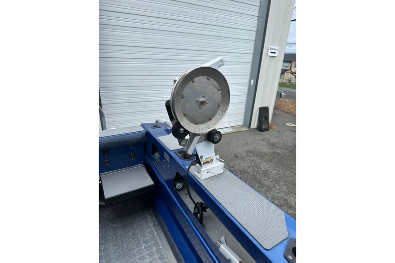 Slide: The Image of 2017 Stabicraft 2100 Supercab boat with mounted fishing reel in a garage setting. - 23