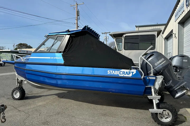 Slide: The Image of 2017 Stabicraft 2100 Supercab boat with Yamaha engine, parked outdoors. - 24