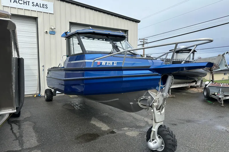 Slide: The Image of 2017 Stabicraft 2100 Supercab boat in blue, parked outside a yacht sales building. - 3