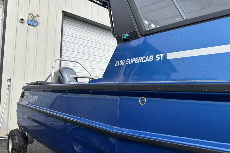 Slide: The Image of 2017 Stabicraft 2100 Supercab boat, blue exterior, parked near a garage door. - 4