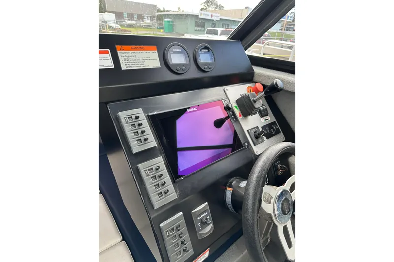 Slide: The Image of Control panel of a 2017 Stabicraft 2100 Supercab boat with steering wheel and gauges. - 7