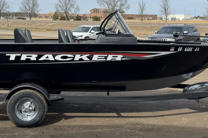 Slide: The Image of 2025 Tracker Pro Guide V-175 WT boat on trailer, parked outdoors. - 4