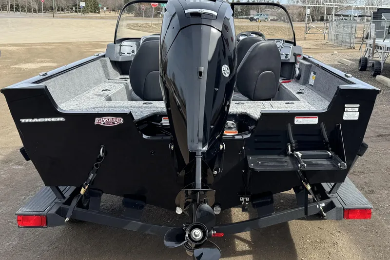 Slide: The Image of 2025 Tracker Pro Guide V-175 WT boat, rear view with outboard motor and trailer. - 5