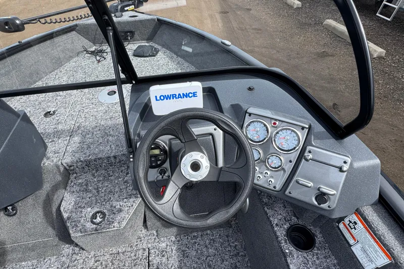 Slide: The Image of 2025 Tracker Pro Guide V-175 WT boat dashboard with steering wheel and gauges. - 8
