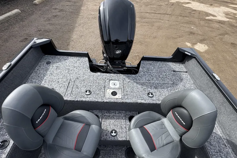 Slide: The Image of 2025 Tracker Pro Guide V-175 WT boat interior with two gray seats and motor. - 9