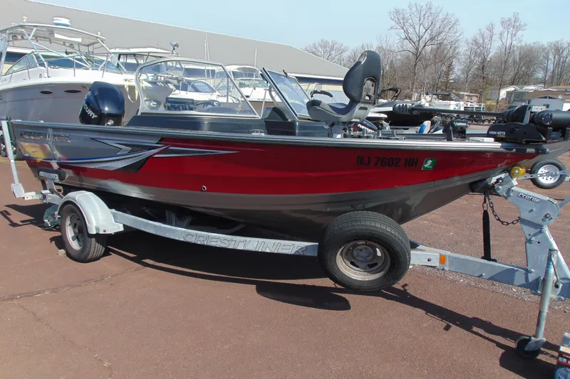 The Image of 2018 Crestliner 1850 Raptor WT boat on trailer, parked outdoors. - 1