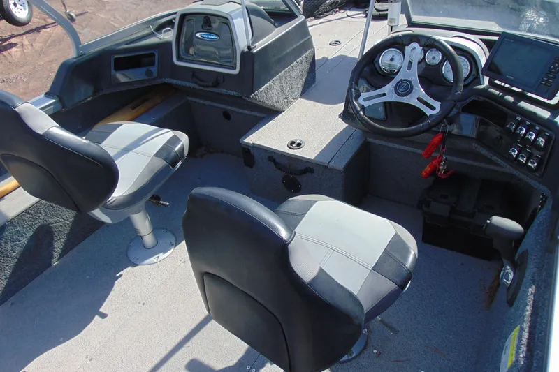 Slide: The Image of 2018 Crestliner 1850 Raptor WT boat interior with steering wheel and seating. - 9