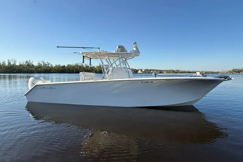 The Image of 2020 Sea Hunter 31 Tournament boat on calm water under clear blue sky. - 0