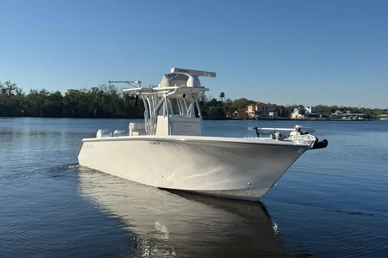 Slide: The Image of 2020 Sea Hunter 31 Tournament boat on calm water, clear sky background. - 2