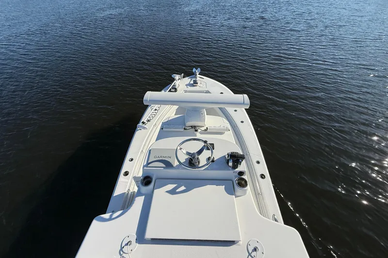 Slide: The Image of 2020 Sea Hunter 31 Tournament boat on calm water, featuring Garmin equipment. - 21