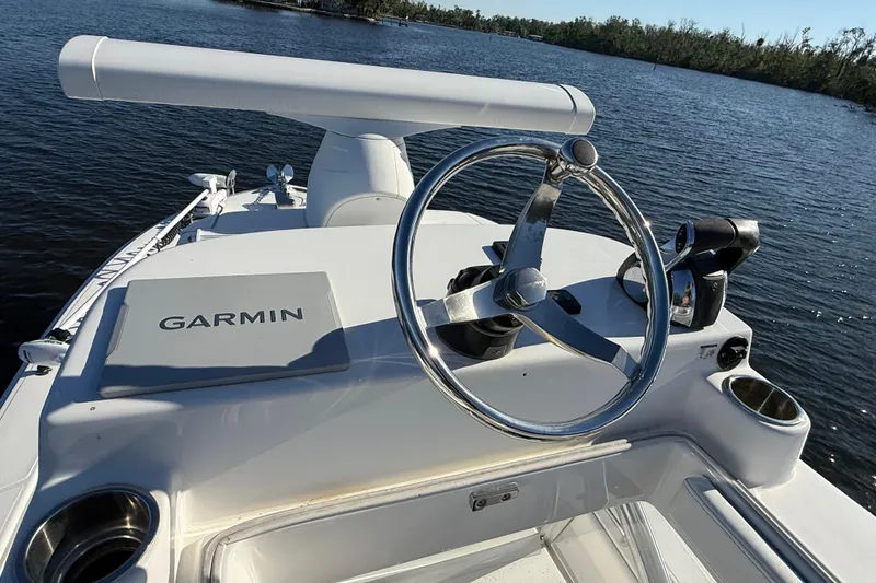 Slide: The Image of 2020 Sea Hunter 31 Tournament boat helm with Garmin navigation system on calm water. - 22