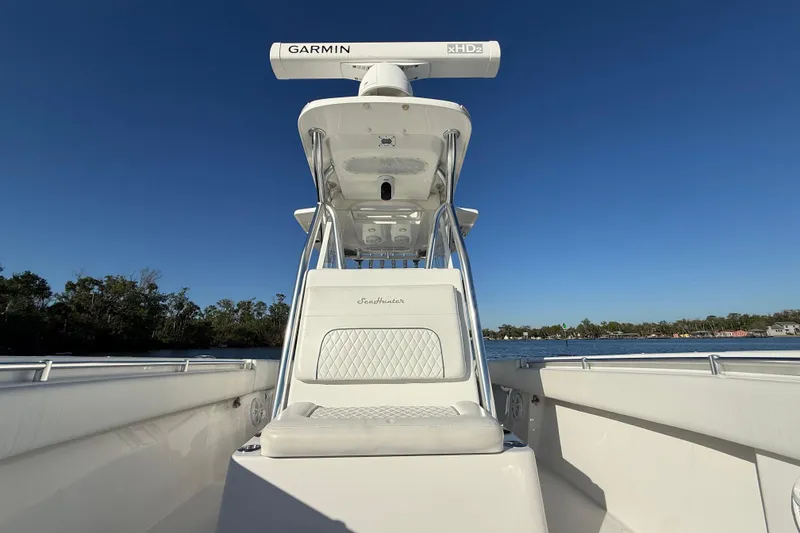 Slide: The Image of 2020 Sea Hunter 31 Tournament boat with Garmin radar, on calm water under clear blue sky. - 23