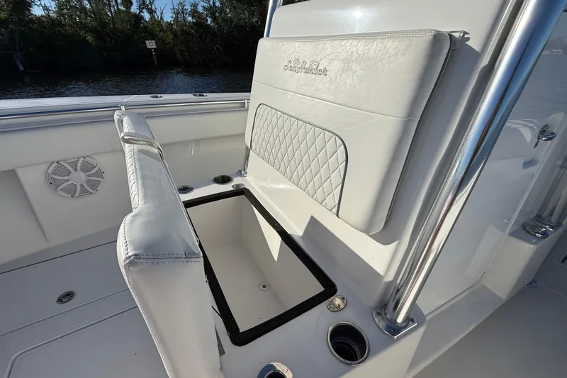 Slide: The Image of 2020 Sea Hunter 31 Tournament boat interior with cushioned seating and storage compartment. - 24