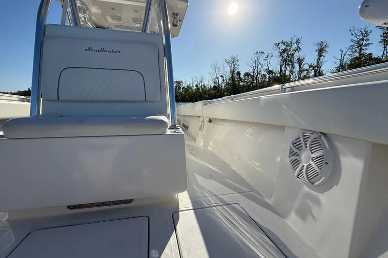 Slide: The Image of 2020 Sea Hunter 31 Tournament boat interior with seating and speakers under sunny sky. - 27