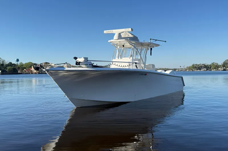 Slide: The Image of 2020 Sea Hunter 31 Tournament boat on calm water under clear blue sky. - 3