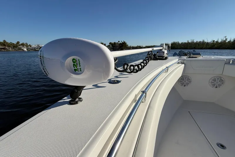 Slide: The Image of 2020 Sea Hunter 31 Tournament boat on calm water, featuring a trolling motor. - 31