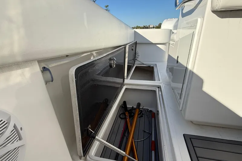 Slide: The Image of 2020 Sea Hunter 31 Tournament boat storage compartments with fishing gear. - 33