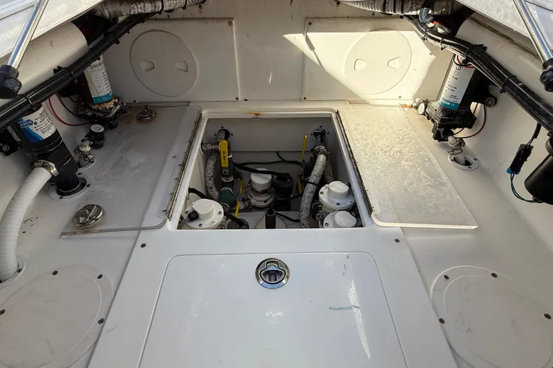 Slide: The Image of Engine compartment of a 2020 Sea Hunter 31 Tournament boat, showcasing mechanical components. - 34