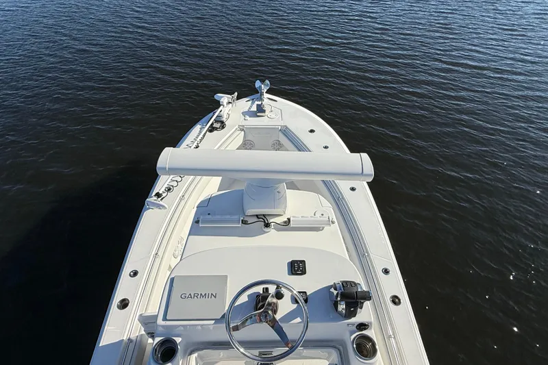 Slide: The Image of 2020 Sea Hunter 31 Tournament boat on calm water, featuring Garmin navigation system. - 35