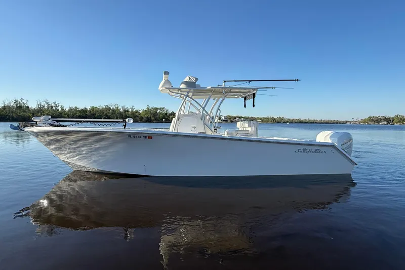 Slide: The Image of 2020 Sea Hunter 31 Tournament boat on calm water under clear blue sky. - 4