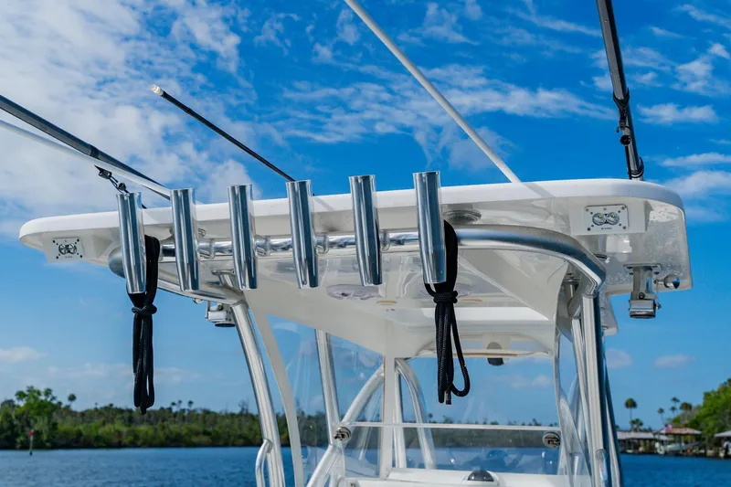 Slide: The Image of 2020 SeaHunter 31 Tournament boat with rod holders against a clear blue sky. - 41