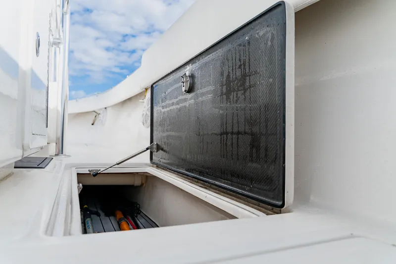 Slide: The Image of Storage compartment on a 2020 SeaHunter 31 Tournament boat under a blue sky. - 42