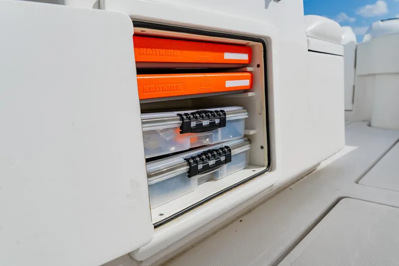 Slide: The Image of Storage compartment on a 2020 SeaHunter 31 Tournament boat with organized tackle boxes. - 44