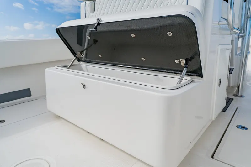Slide: The Image of Open storage compartment on 2020 SeaHunter 31 Tournament boat deck. - 48