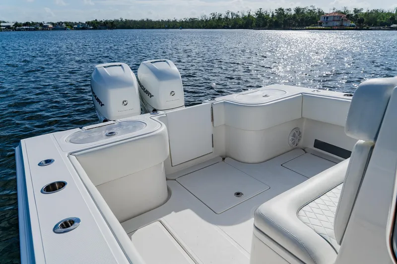 Slide: The Image of 2020 SeaHunter 31 Tournament boat with dual Mercury engines on a sunny lake. - 49