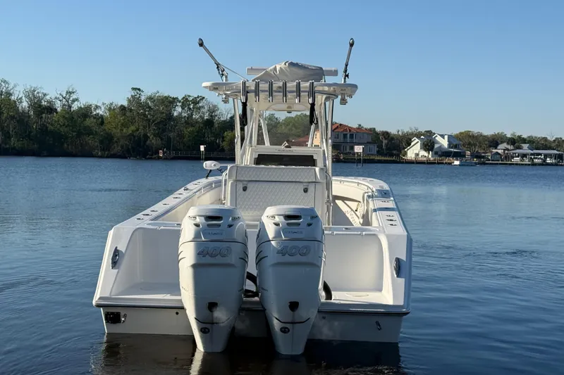 Slide: The Image of 2020 Sea Hunter 31 Tournament boat with dual engines on a calm lake. - 5