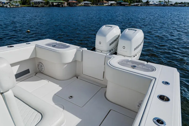 Slide: The Image of 2020 SeaHunter 31 Tournament boat with twin Mercury engines on a calm lake. - 50