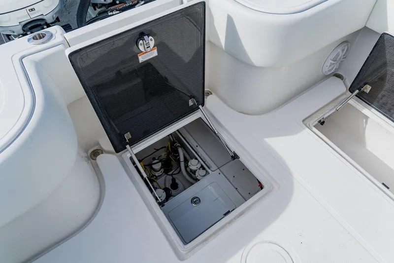 Slide: The Image of Open hatch on 2020 SeaHunter 31 Tournament boat, revealing internal compartments and equipment. - 58