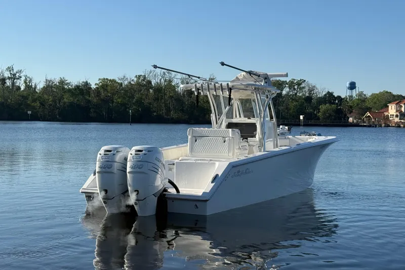 Slide: The Image of 2020 Sea Hunter 31 Tournament boat with dual engines on a calm lake. - 6